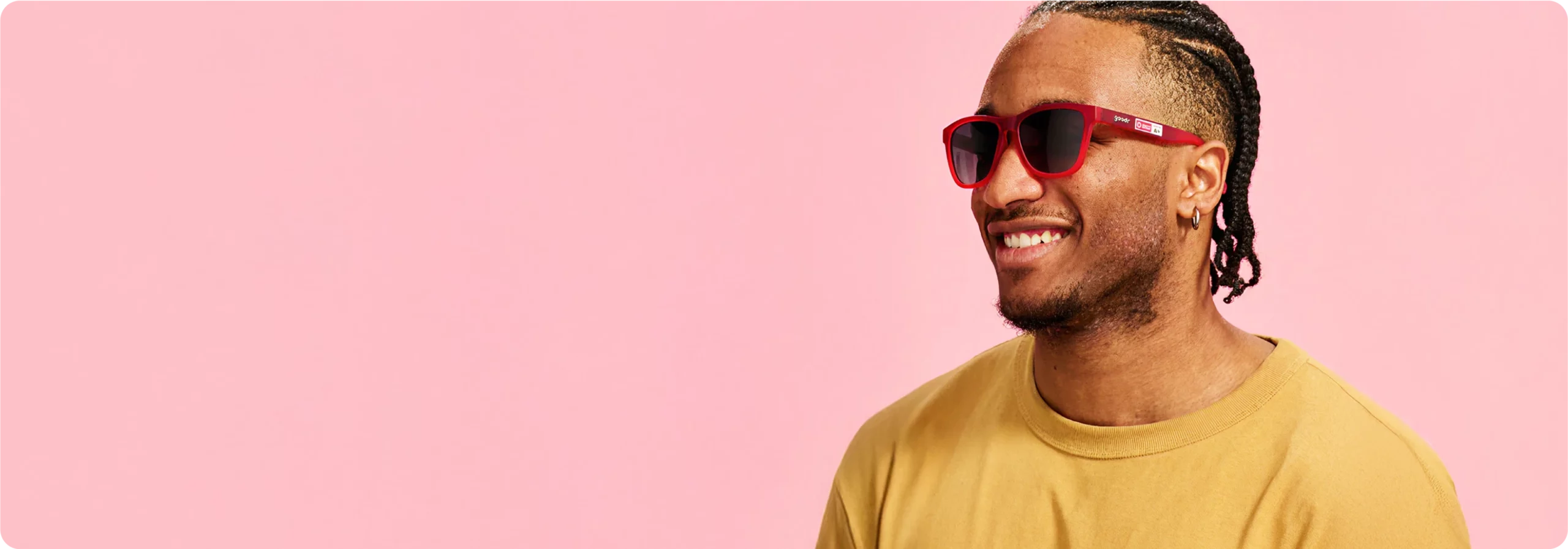Goodr: Smiling man wearing red Goodr sunglasses
